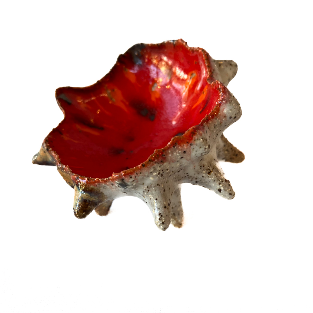 1/2 Sea Urchin Ceramic Sculpture with a vibrant red glase inner and an organic outer