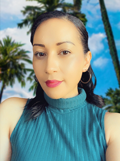 Katrina Iosia portrait in Cairns Dec 2022. Woman with red lipstick wears a teal coloured top with hoop earrings and palmtrees in background