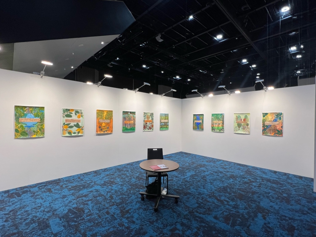 Ten works on paper are installed on two white walls. 